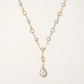 Long gold-plated necklace with alternating freshwater pearls and crystal bezels, featuring a large baroque pearl pendant